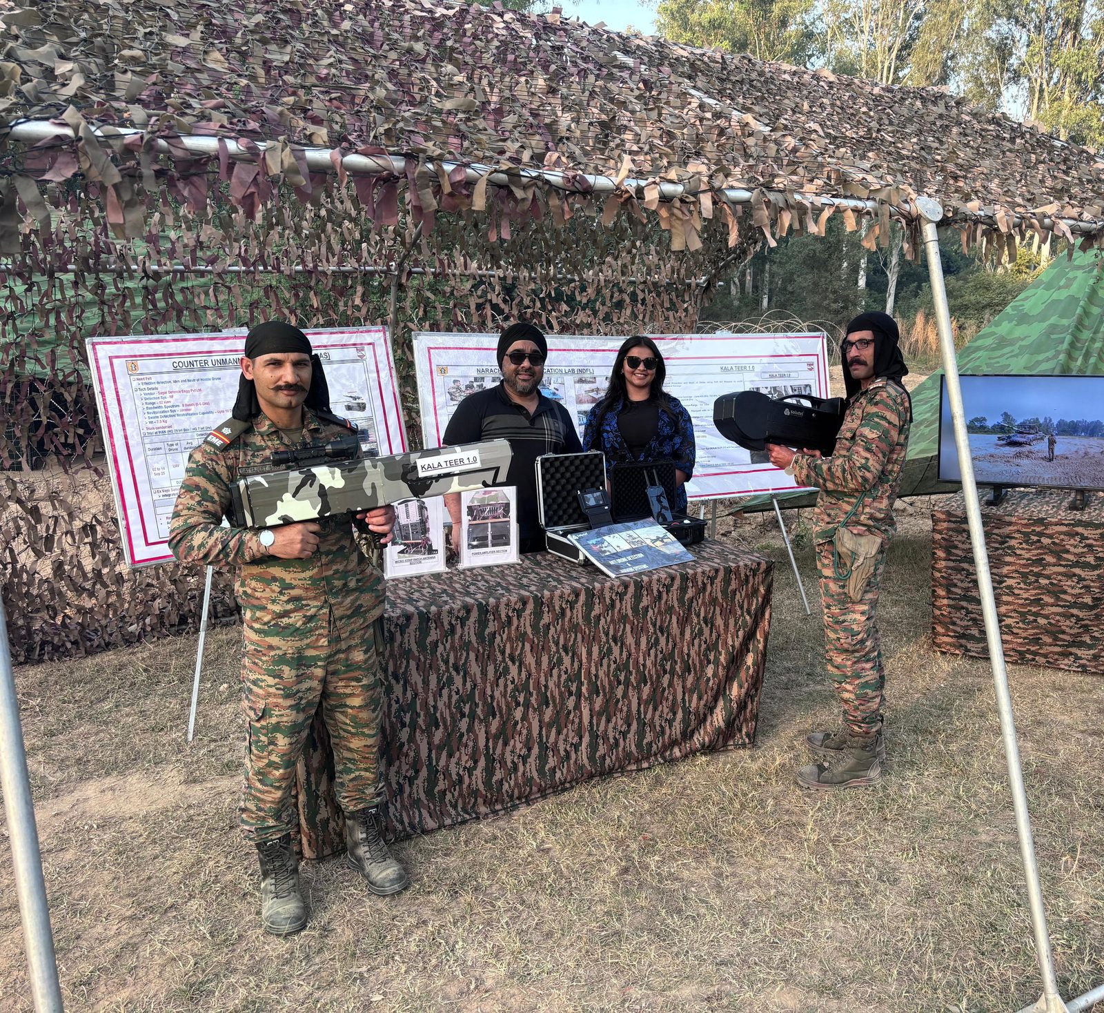 Soldiers holding Kala Teer counter-drone jamming systems at a defence exhibition booth