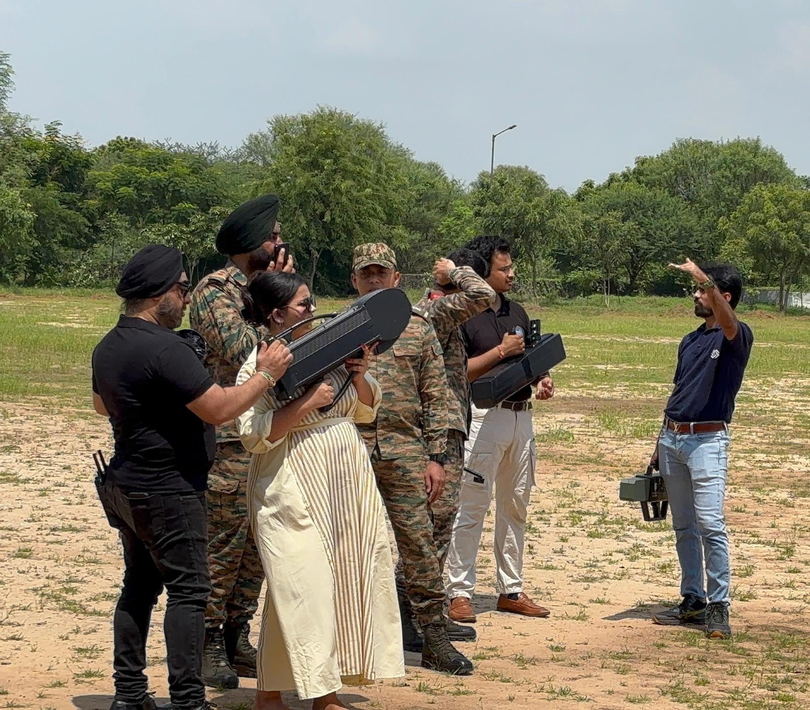 Group field-testing multiple handheld anti-drone jamming units in an open training ground