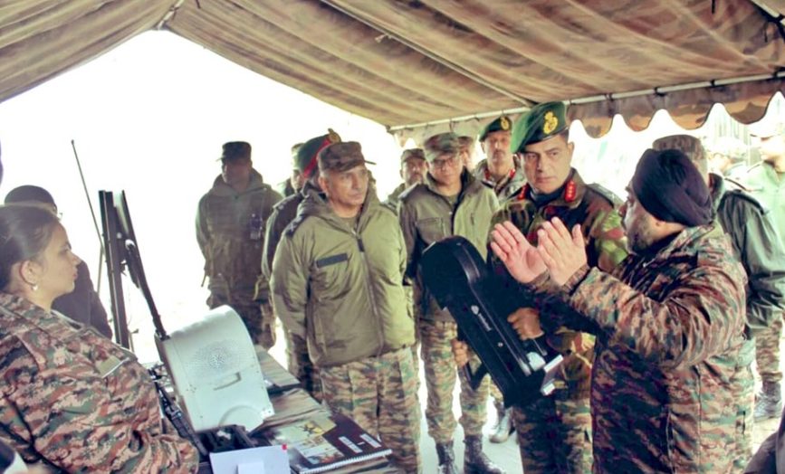 Military officers briefed on a Black Wave Defence anti-drone jammer gun inside a command tent