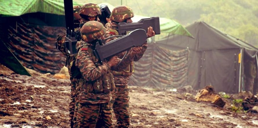 Soldiers aiming shoulder-mounted anti-drone jammer guns skyward during a field demonstration