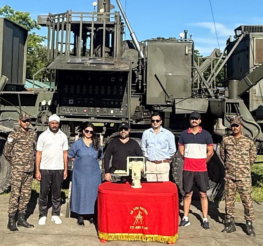 Team posing beside a large counter-drone radar and jamming vehicle system